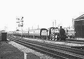 Close up showing a GWR 0-6-0 'Dean goods' locomotive standing on one of the approach roads in front of the sheds with the doors to the repair shops on the right