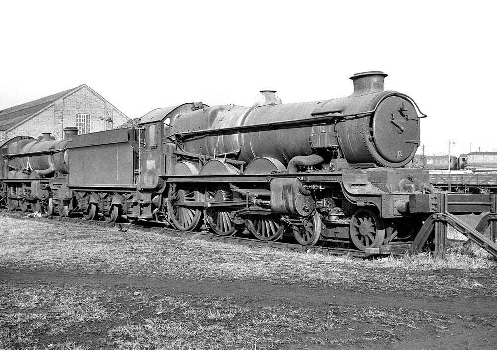 British Railways built 4-6-0 Castle Class No 7014 'Caerhays Castle' is standing in line on Tyseley shed's scrap line on 31st January 1965 with No 5014 behind