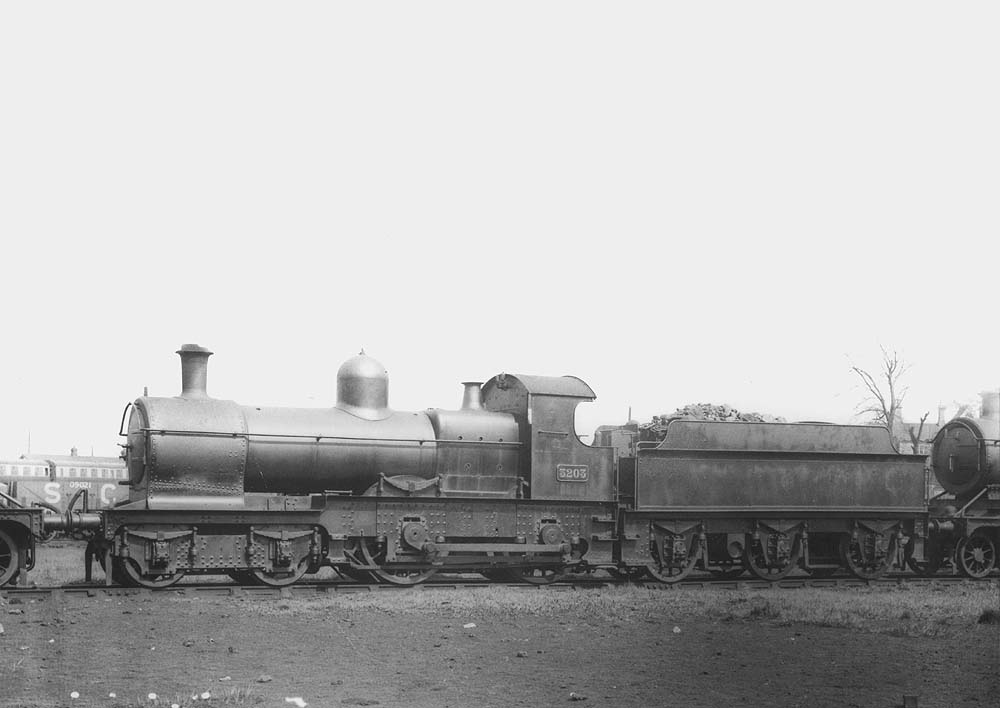 GWR 4-4-0 Dukedog class No 3203, a straight outside-framed locomotive, is seen standing in line coaled and serviced one Winter's Sunday at Tyseley