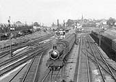 An unidentified ex-GWR 4-6-0 Hall class locomotive is seen at the head of a three-coach local passenger service from Stratford upon Avon in the early 1960s