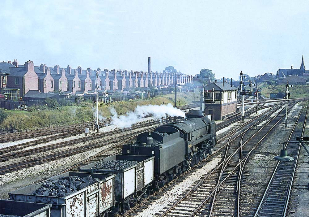 An unidentified British Railways Standard class 9F 2-10-0 is seen at the head of an up coal train bound for the south on 2nd September 1964