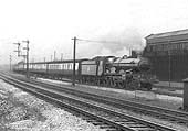 Ex-GWR 4-6-0 Castle class No 4079 'Pendennis Castle' is seen working hard as it passes Tyseley Goods shed at the head of an up express