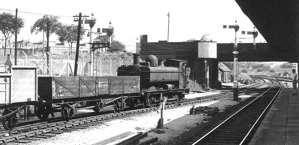 Ex-GWR 0-6-0PT 57xx Class No 8737 is seen shunting a rake of wagons into Tyseley goods yard in the summer of 1959