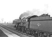 British Railways built 4-6-0 Castle class No 7024 'Powis Castle' is seen passing through Tyseley station on a down express with Tyseley North Signal box in the distance