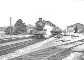 Ex-GWR 49xx Class 4-6-0 No 5912 'Queens Hall' heads an up train past Coventry Road Yard's good shed in 1959