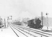 Ex-Great Western Railway 30xx Class 2-8-0 No 3028 stands on the up refuge loop during the Winter of 1955