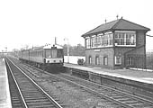 A three car Diesel Multiple Unit is seen arriving at the up platform on a local passenger service on 3rd April 1965