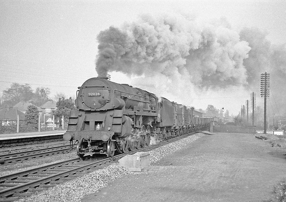 British Railways Standard Class 9F 2-10-0 No 92028 builds up speed for Hatton Bank on 22nd April 1965.