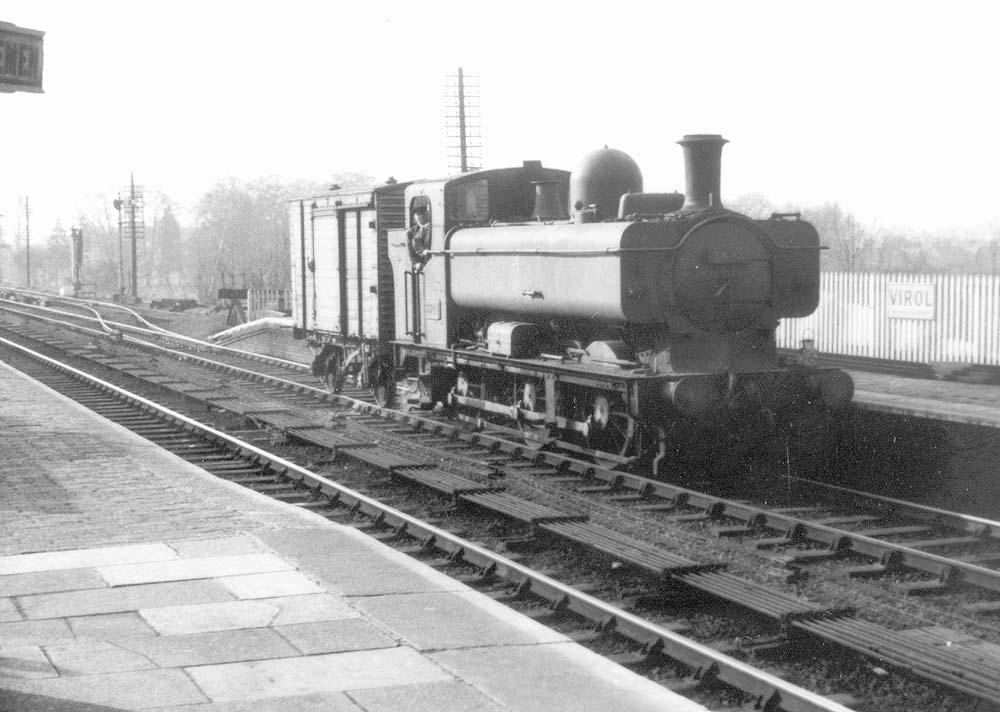 Ex-GWR 0-6-0PT 57xx class Pannier Tank No 3624 glides through the station on the up line with a single van in tow