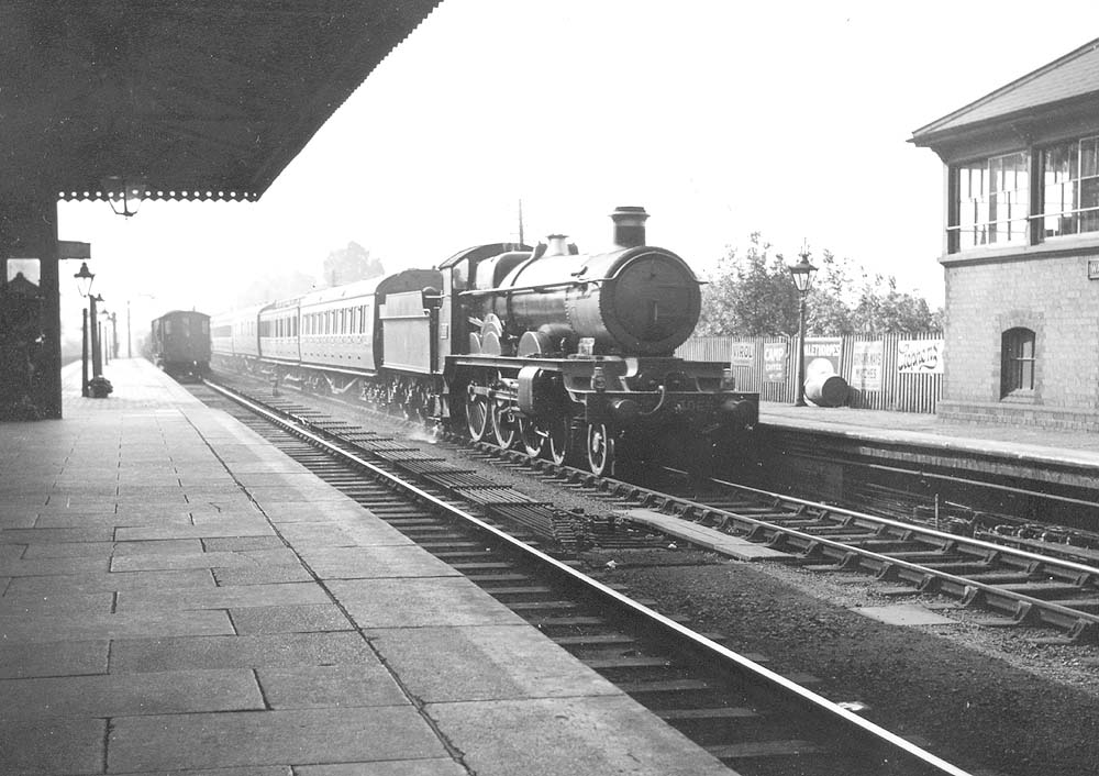 GWR 4-6-0 Star class No 4065 'Evesham Abbey' runs through the station on an up express two years before it was rebuilt as a Castle class locomotive