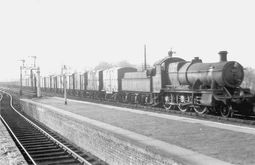 Ex-GWR 2-6-0 Mogul No 5313 is seen ghosting pass Warwick station at the head of a long up semi-fitted express goods train