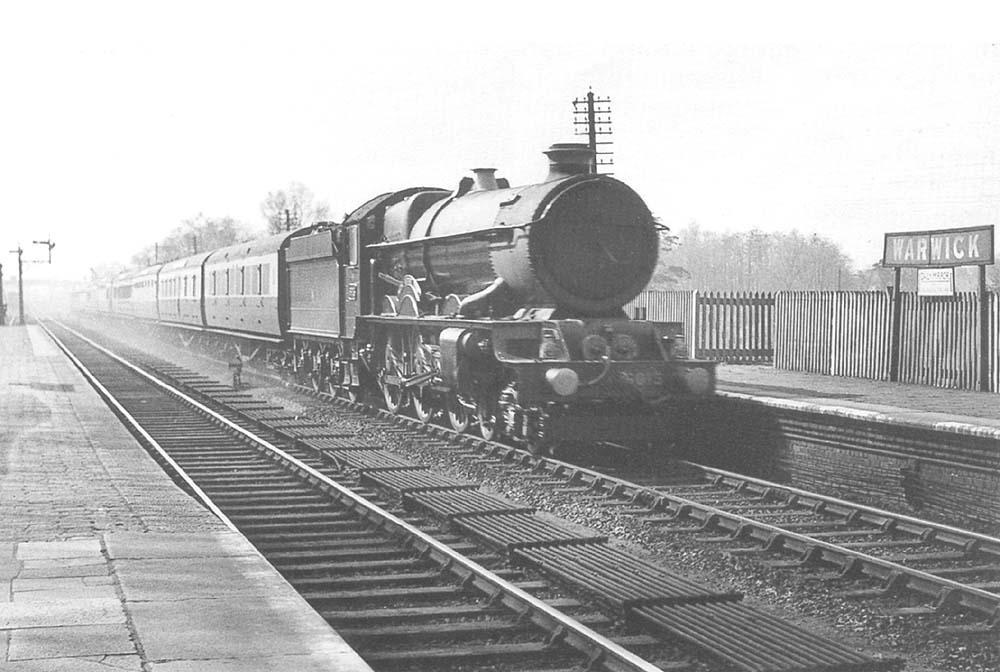GWR 4-6-0 No 6015 'King Richard III is seen passing through the station at speed at the head of an up express to Paddington