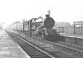 GWR 4-6-0 No 6015 'King Richard III is seen passing through the station at speed at the head of an up express