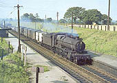 Ex-GWR 4-6-0 Grange class No 6870 'Bodicote Grange' is seen passing through Whitlocks End Halt on an up freight service