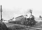 GWR 3232 Class 2-4-0 No 3237 is seen sporting express head codes with the first two carriages carring headboards