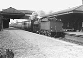 GWR 2-6-0 Aberdare class No 2632 is seen running tender first with a long empty coaching stock working as it passes through the station