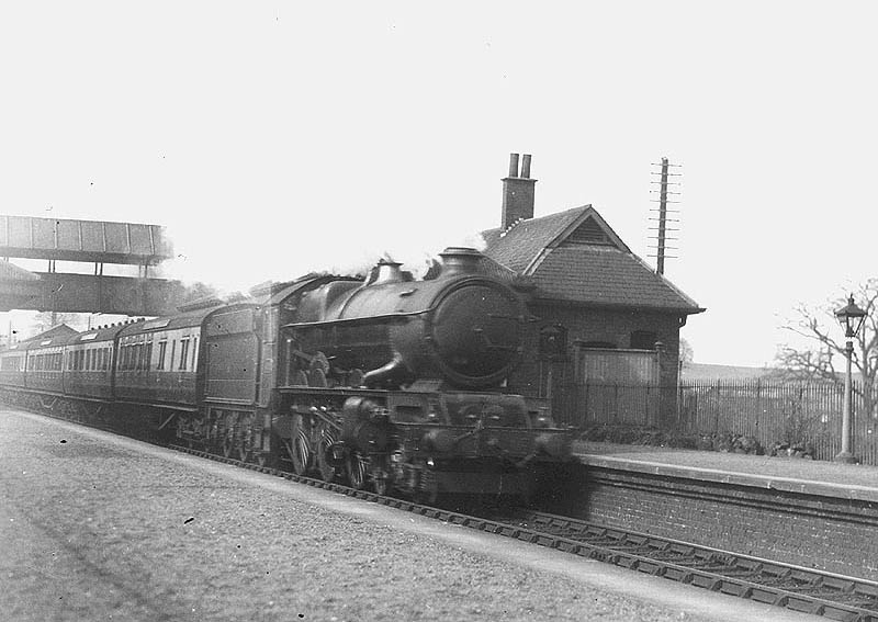 GWR 4-6-0 No 6017 'King Edward IV' is seen at the head of an up Birkenhead to Paddington express as it passes through the original station
