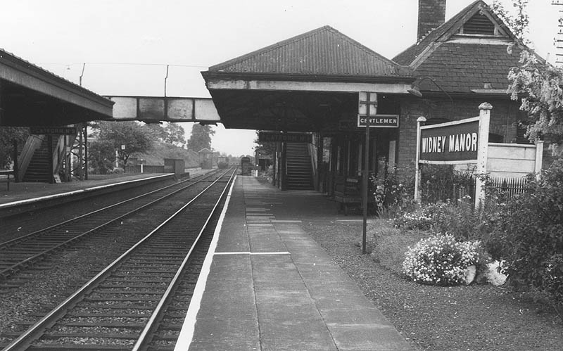 View along Platform 1, now the Up Main, looking towards Leamington with a DMU approaching along the Down Main line
