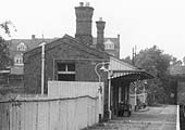 Close up showing the up platform building viewed from the Stratford upon Avon side of Yardley Wood station with the Highfield Road bridge beyond