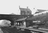 View of the main station building located on the up platform with a station porter entering the booking office