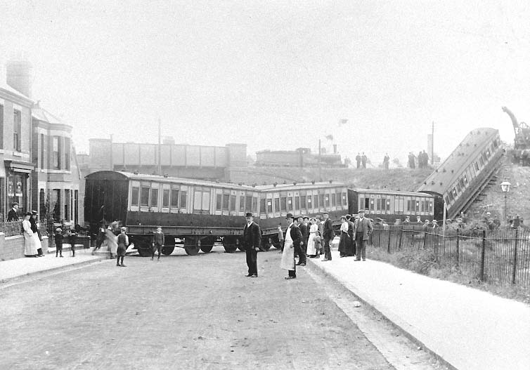 Another view of the four six-wheel carriages stranded at the junction of Albany Road and Broomfield Road with the break down crane ready to lift