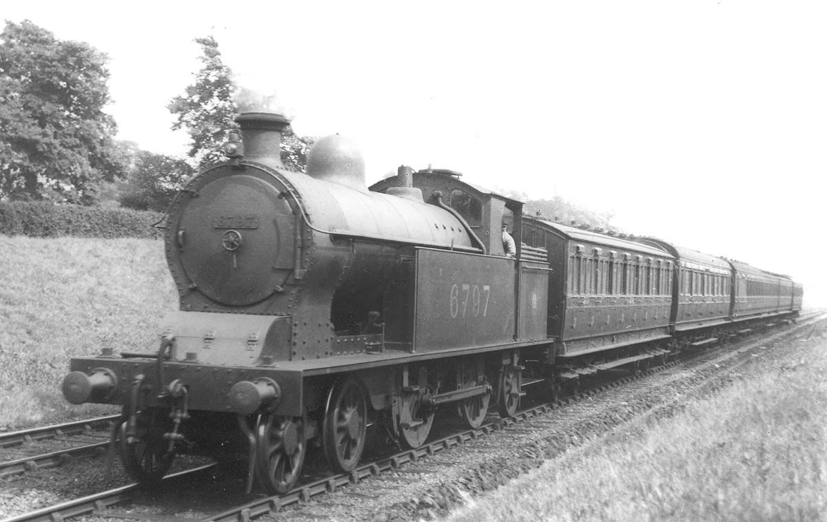 Ex-LNWR 2P 4-4-2T Precursor Tank No 6796 is seen on a down Rugby to Birmingham local passenger service near Berkswell