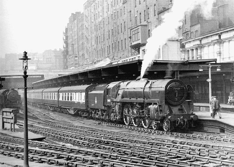 British Railways Standard Class 7 4-6-2 Britannia class No 70031 'Byron' is blowing off steam at the head of the 12 45pm from Manchester London Road