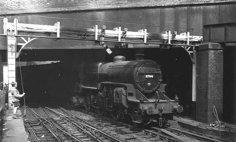 Ex-LMS 5P4F 2-6-0 'Crab' No 2764 is seen passing under Worcester Street bridge with the tunnel seen in the distance, as it enters New Street station