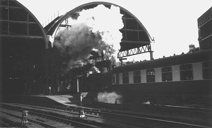 Ex-LMS 4F 0-6-0 No 43875 is seen leaving Platform 9 as it banks a heavy express train through the tunnel on the West Suburban Railway