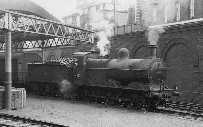 Ex-Midland Railway 3F 0-6-0 No 43523 is seen working in Fish Sidings with the Midland Carriage siding behind circa 1954