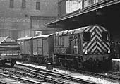 British Railways Class 08 0-6-0 D3840 is seen shunting a pair of Vans in the former LNWR parcels siding on 18th February 1961