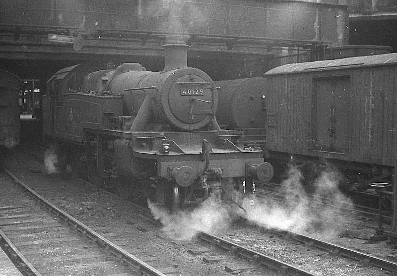 Ex-LMS 3P 2-6-2T No 40129 is seen wreathed in steam as it pauses between pilot duties at New Street station
