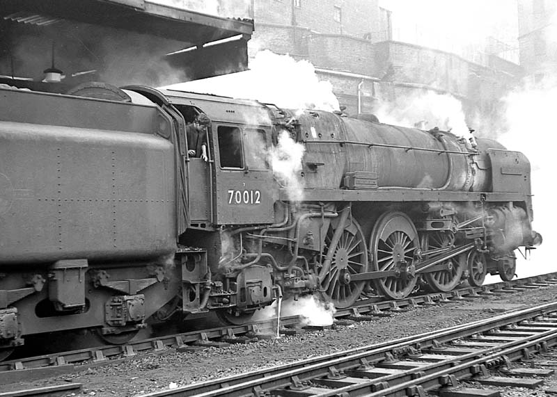 British Railways Standard Class 7MT 4-6-2 No 70012 'John of Gaunt' is seen wreathed in steam on 15th February 1964