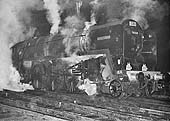 BR Standard Class 7MT 4-6-2 No 70000 'Britannia' is seen wreathed in steam on the evening of 18th January 1964