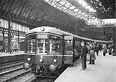 An evening commuter Diesel Multiple Unit waits to depart from platform 9 for Castle Bromwich in the late 1950s