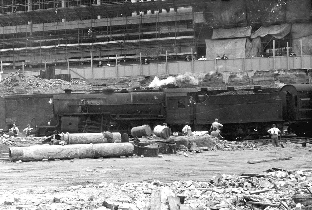 Ex-LMS 2-6-0 5P4F 'Crab' No 42707 passes through a demolished New Street station in 1964