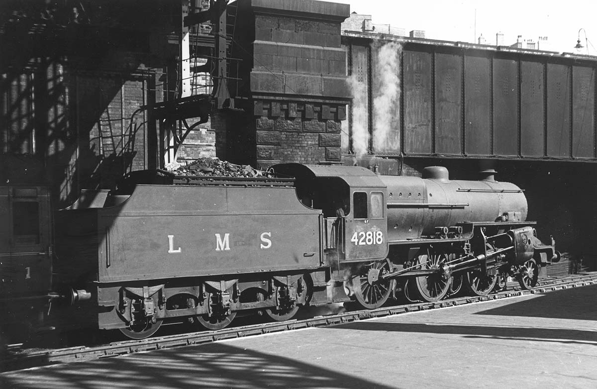 Ex-LMS 5P4F 2-6-0 'Crab' No 42818 is seen on pilot duties as it takes forward from Platform 7 an empty stock working to Vauxhall carriage sidings