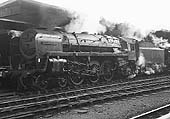 British Railways Standard Class 7 4-6-2 No 70033 'Charles Dickens' is seen wreathed in steam at the East end of Platform 4 on an up express service