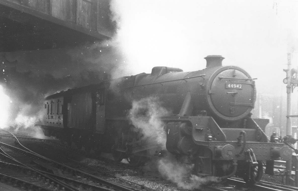 Ex-LMS 5MT 4-6-0 No 44942 is seen leaving Platform 6 with steam leaking from the steam heating pipe on the bufferbeam as it heads the 12 10pm express to Manchester