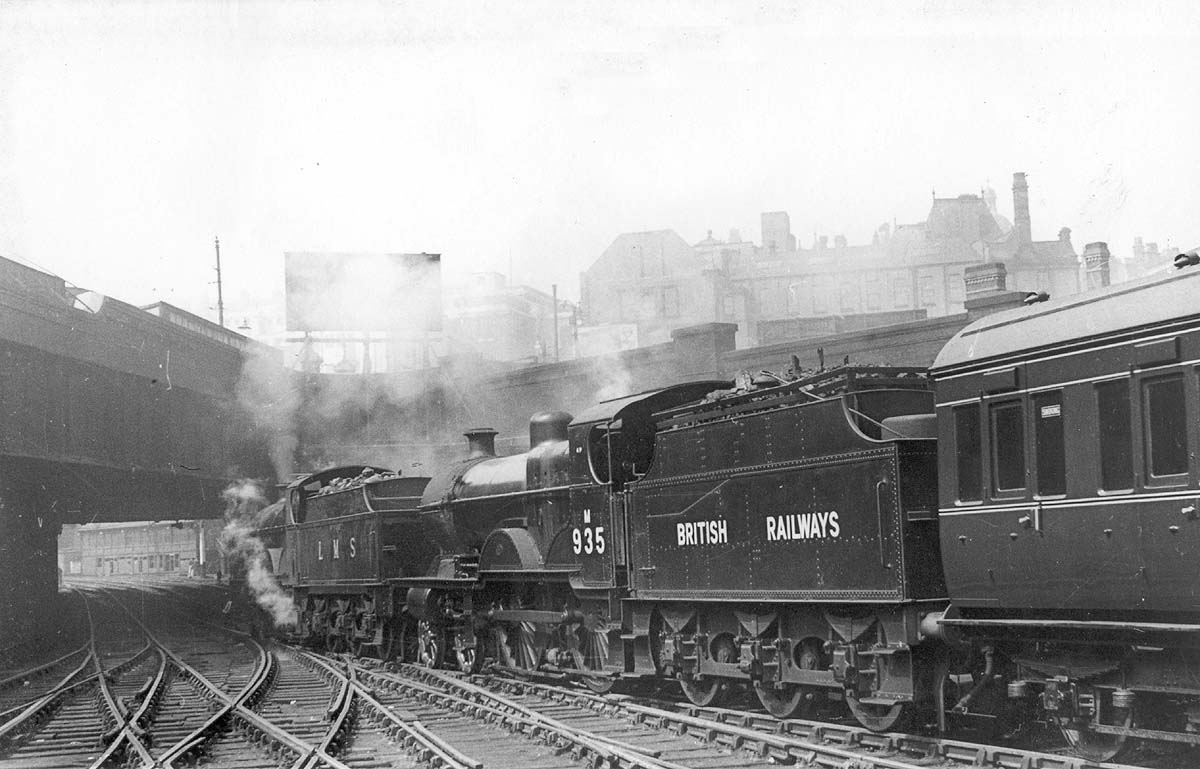 Ex-Midland Railway 4P 4-4-0 Compound No 41035 and exLMS 4P 4-4-0 Compound No M935 are seen leaving the West end of Platform 9 at the head of a Bristol express