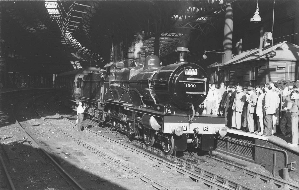 Preserved Midland Railway 4P 4-4-0 Compound No 1000 is seen standing at the East end of Platform 7 with scores of enthusiasts in attendance