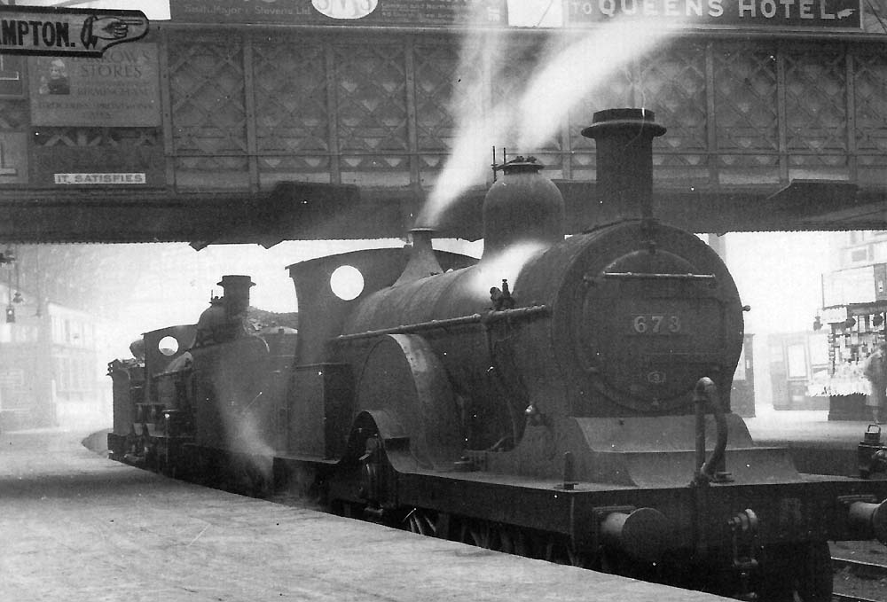 Midland Railway 4-2-2 No 673, a 115 class locomotive, and Midland Railway 2-4-0 No 19 are seen standing light engine at Platform 6 on 1st September 1926