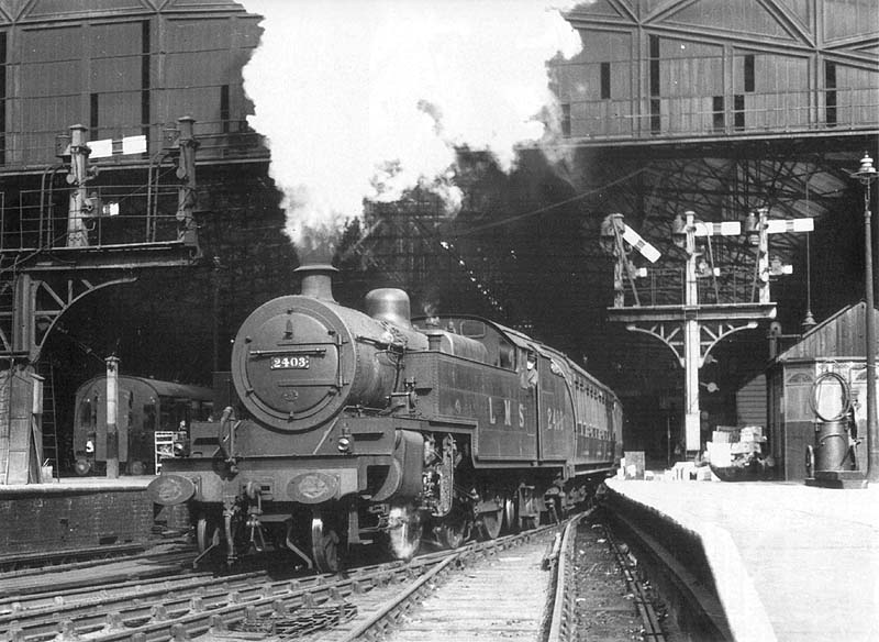 LMS 4MT 2-6-4T No 2403 is seen departing the West end of Platform 3 at the head of a semi-fast express service to Stafford