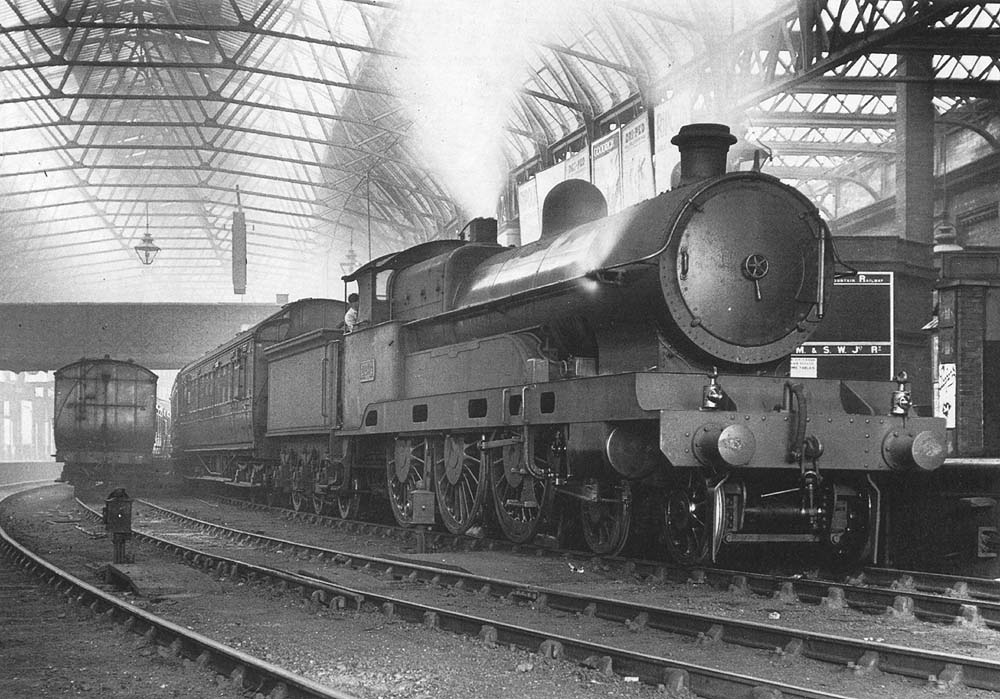 Ex-LNWR 5XP 4-6-0 Claughton class No 2204 'Sir Herbert Walker KCB' is seen at the East end of Platform 4 coupled to a rake of Midland coaching stock on an express service