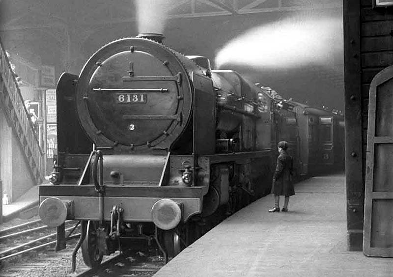 LMS 6P Royal Scot Class 4-6-0 No 6131 'The Royal Warwickshire Regiment' is seen standing at New Street station