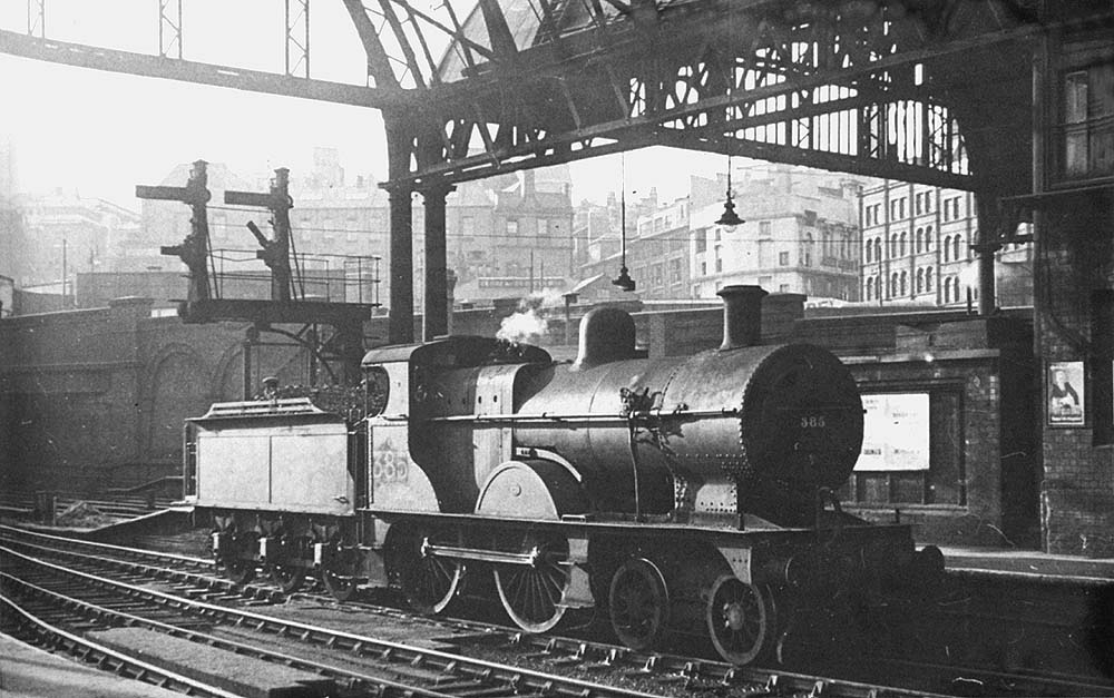 Ex-Midland Railway 2P 4-4-0 No 385 is seen  standing at the West end of the 'down' face of Platform 5 whilst on pilot duties circa 1946