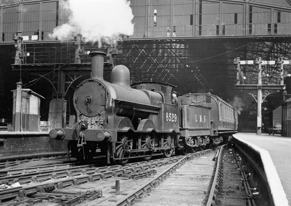 Ex-LNWR 2F 0-6-0 No 8529 is seen acting as West end pilot as it stands at Platform 3 whilst it readies to move the empty stock of a down passenger service