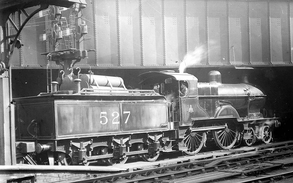 Midland Railway 2P 4-4-0 No 527 is seen with its tender fitted for oil firing whilst standing buffered up to the stops at the East end of Platform 5