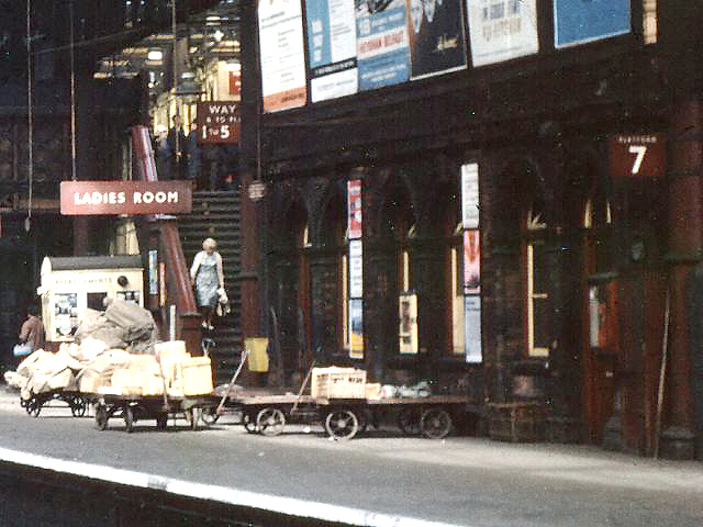 Close up showing some of the several mail and parcel trollies positioned on Platform 7 ready to be loaded onto the next passenger service