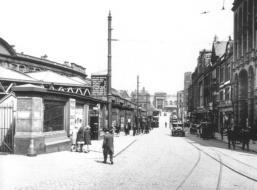 Looking towards the Market Hall along Station Street now with a cobbled surface and electrified tram lines and new buildings in filling the gaps